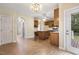 Spacious eat-in kitchen with white walls, wooden cabinets, and access to the deck at 1601 Castalia Dr, Cary, NC 27513