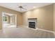 Cozy living room featuring carpet floors, a fireplace, and windows at 1601 Castalia Dr, Cary, NC 27513