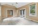 Bright living room featuring a ceiling fan, neutral walls, and access to an outdoor patio through glass doors at 1601 Castalia Dr, Cary, NC 27513