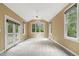 Spacious living room featuring a vaulted ceiling, large windows, and a glass door leading to an outdoor deck at 1601 Castalia Dr, Cary, NC 27513