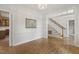 Bright living room featuring hardwood floors, detailed trim, and entryways to other rooms at 1601 Castalia Dr, Cary, NC 27513