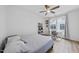 Inviting bedroom with a cozy bed, ceiling fan, and a quaint study area by the window at 1723 Kudrow Ln, Morrisville, NC 27560
