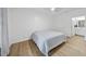 Well-lit bedroom featuring modern floors and a comfortable bed, showcasing a calming and inviting space at 1723 Kudrow Ln, Morrisville, NC 27560
