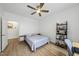 Spacious bedroom featuring a ceiling fan, wood floors, and a cozy bed, with a view into the hallway at 1723 Kudrow Ln, Morrisville, NC 27560