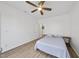 Bright bedroom with a ceiling fan, light wood floors, and a comfortable bed with a light blue quilt at 1723 Kudrow Ln, Morrisville, NC 27560