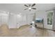 Bright living room featuring wood floors, a ceiling fan, and large windows offering natural light at 1723 Kudrow Ln, Morrisville, NC 27560