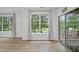 Bright living room with wood floors, large windows, and glass sliding door leading to the outside at 1723 Kudrow Ln, Morrisville, NC 27560