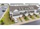 Aerial view of a street of townhomes with well-manicured lawns at 19 Willow Green Dr, Clayton, NC 27527