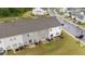Aerial view of townhome backyards with sliding glass doors and patios at 19 Willow Green Dr, Clayton, NC 27527