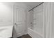 Clean bathroom showcases a tub with shower and storage shelves at 19 Willow Green Dr, Clayton, NC 27527
