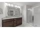 Primary bathroom featuring a double vanity, granite countertop, modern lighting, and a glass shower at 19 Willow Green Dr, Clayton, NC 27527