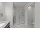 Modern bathroom with granite vanity, updated lighting, and glass shower doors at 19 Willow Green Dr, Clayton, NC 27527