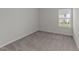 Neutral bedroom with carpeted floors and a bright window at 19 Willow Green Dr, Clayton, NC 27527