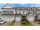 Charming townhome with attached garages, manicured lawn, and classic architectural details at 19 Willow Green Dr, Clayton, NC 27527