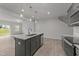 Open-concept kitchen with stainless steel appliances, center island, and views of the living area at 19 Willow Green Dr, Clayton, NC 27527