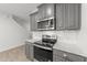 Close up of the modern stainless steel oven and microwave in the kitchen with white tile backsplash at 19 Willow Green Dr, Clayton, NC 27527