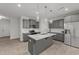Stylish kitchen with grey cabinetry, stainless steel appliances, and island with pendant lighting at 19 Willow Green Dr, Clayton, NC 27527