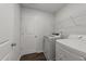 Functional laundry room with modern washer and dryer, plus convenient storage shelving at 19 Willow Green Dr, Clayton, NC 27527