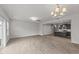 Bright living room with wood floors, seamlessly connecting to a modern kitchen space at 19 Willow Green Dr, Clayton, NC 27527