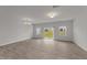 Bright living room featuring a sliding glass door, neutral paint, and modern flooring at 19 Willow Green Dr, Clayton, NC 27527