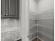 Walk-in pantry with adjustable wire shelving and ample storage space, located in the kitchen at 19 Willow Green Dr, Clayton, NC 27527