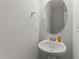Charming powder room features a pedestal sink and decorative mirror at 19 Willow Green Dr, Clayton, NC 27527