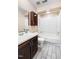 Bathroom featuring a combination tub and shower with wood cabinets at 200 W Woodcroft Pkwy # 52A, Durham, NC 27713
