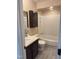 Compact bathroom featuring a shower and bath tub combo with dark cabinetry at 200 W Woodcroft Pkwy # 52A, Durham, NC 27713