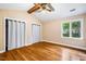 Spacious bedroom featuring hardwood floors, a vaulted ceiling, and natural light at 200 W Woodcroft Pkwy # 52A, Durham, NC 27713