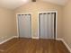 Vaulted ceiling bedroom with hardwood floors, neutral paint, and dual closet at 200 W Woodcroft Pkwy # 52A, Durham, NC 27713