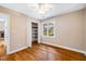 Bright bedroom boasts hardwood floors, a window, and closet with shelving at 200 W Woodcroft Pkwy # 52A, Durham, NC 27713