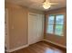 Neutral bedroom featuring a ceiling fan, double door closet, and window at 200 W Woodcroft Pkwy # 52A, Durham, NC 27713