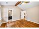 Bedroom features wood flooring, neutral walls, and a view of the attached bathroom at 200 W Woodcroft Pkwy # 52A, Durham, NC 27713
