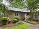 Charming brick home featuring a landscaped front yard and a welcoming entryway with a white railed porch at 200 W Woodcroft Pkwy # 52A, Durham, NC 27713