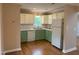 Spacious kitchen with white cabinets, hardwood floors, stainless steel appliances, and plenty of counter space at 200 W Woodcroft Pkwy # 52A, Durham, NC 27713