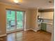 Bright kitchen nook featuring hardwood floors, a large window, white cabinets, and modern appliances at 200 W Woodcroft Pkwy # 52A, Durham, NC 27713