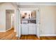 Convenient laundry closet with washer, dryer, and shelving for storage at 200 W Woodcroft Pkwy # 52A, Durham, NC 27713