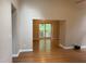 Open floor plan showcasing hardwood floors and a large window providing a view of the outdoors at 200 W Woodcroft Pkwy # 52A, Durham, NC 27713