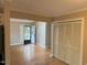 Neutral living space featuring hardwood floors, a closet, and an open doorway leading to the front door at 200 W Woodcroft Pkwy # 52A, Durham, NC 27713