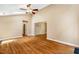 Spacious living area with gleaming hardwood floors, ceiling fan, and neutral paint at 200 W Woodcroft Pkwy # 52A, Durham, NC 27713
