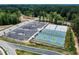 Aerial view of the community pickleball and basketball courts with parking and surrounding green space at 2003 Pilot Mountain Ct, Apex, NC 27502