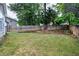 Expansive back yard with lush lawn, mature trees, and sturdy wooden fencing at 2003 Pilot Mountain Ct, Apex, NC 27502