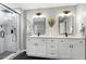 Elegant bathroom showcasing a modern glass shower, dual vanity sinks, and sophisticated lighting fixtures at 2003 Pilot Mountain Ct, Apex, NC 27502