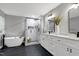 Modern bathroom with a soaking tub, frameless shower, and double vanity at 2003 Pilot Mountain Ct, Apex, NC 27502