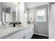 Elegant bathroom boasts dual sinks, marble countertops, and white cabinetry at 2003 Pilot Mountain Ct, Apex, NC 27502