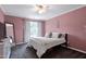 Bedroom features soft pink walls, plush carpeting, a bed, and natural light at 2003 Pilot Mountain Ct, Apex, NC 27502
