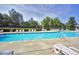 Relaxing community pool area with ample seating and lush landscaping, perfect for enjoying sunny days at 2003 Pilot Mountain Ct, Apex, NC 27502