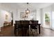 Elegant dining space with hardwood flooring, a statement light fixture, and ample seating at 2003 Pilot Mountain Ct, Apex, NC 27502