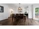 Elegant dining room with modern light fixture and ample seating at 2003 Pilot Mountain Ct, Apex, NC 27502