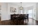 Bright dining room boasts modern lighting, sleek wood floors, and stylish furniture arrangement at 2003 Pilot Mountain Ct, Apex, NC 27502